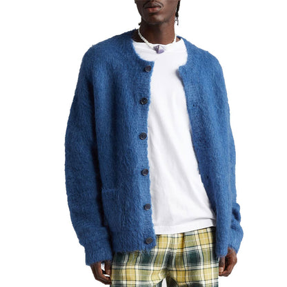 Man wearing a blue custom wholesale wool blend solid crew neck cardigan sweater over a white T-shirt