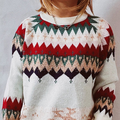 Close-up of a custom knit Fair Isle cashmere sweater featuring intricate red, green, and beige patterns, showcasing the high-quality craftsmanship and luxurious material.