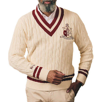 Man wearing cream cable knit sweater with maroon trim and “Kappa Alpha Psi" Logo embroidery
