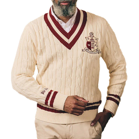 Man wearing cream cable knit sweater with maroon trim and “Kappa Alpha Psi" Logo embroidery