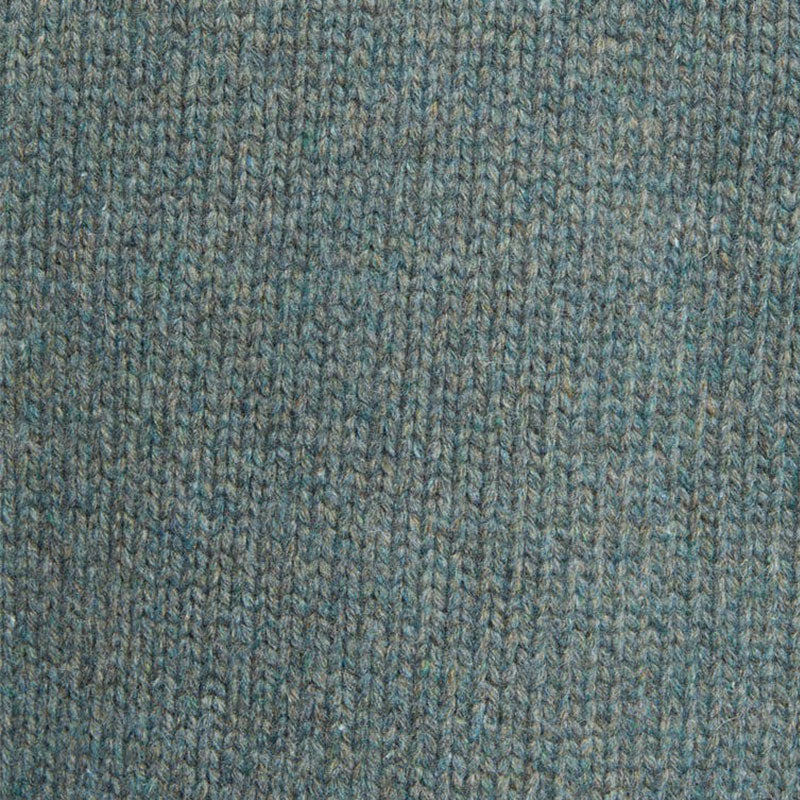 Close-up detail of the custom wool blend cardigan fabric in light grey, highlighting the knit texture.