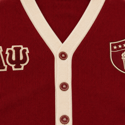 Red knit cardigan with cream V-neck trim, buttons and Greek letter embroidery