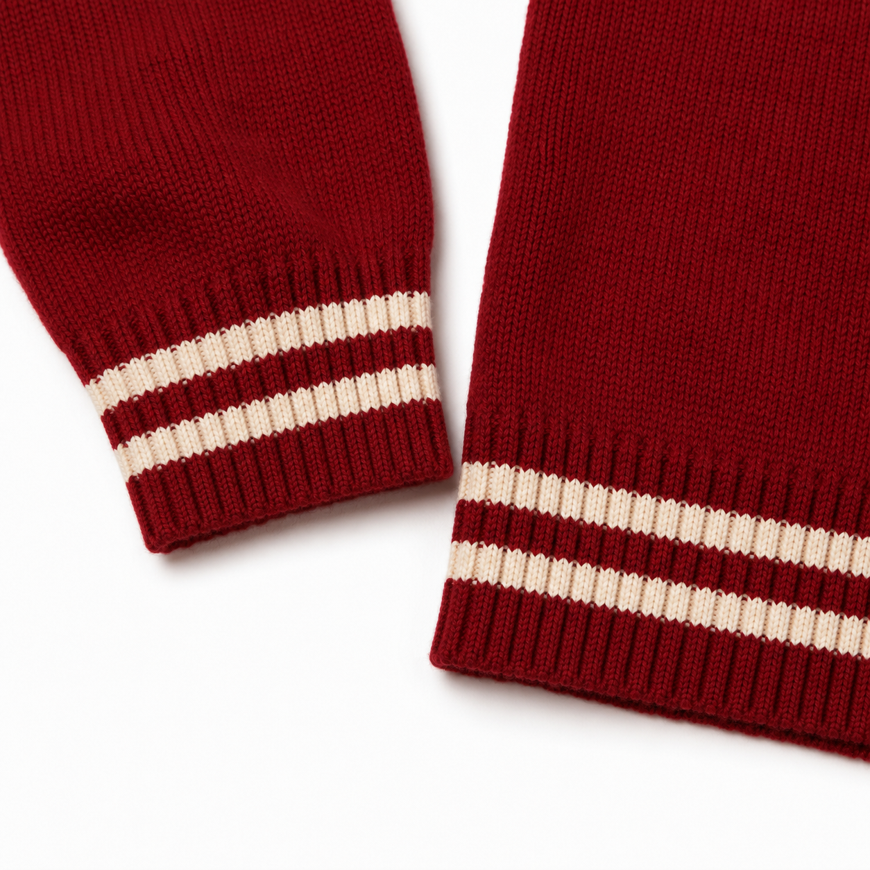 Red varsity cardigan with cream striped ribbed cuffs and hem