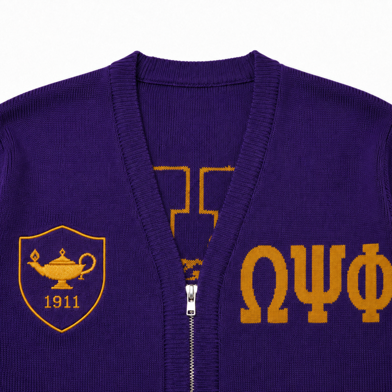 Close-up of purple V-neck knit cardigan with ribbed placket, metal zipper and gold Greek chest details 