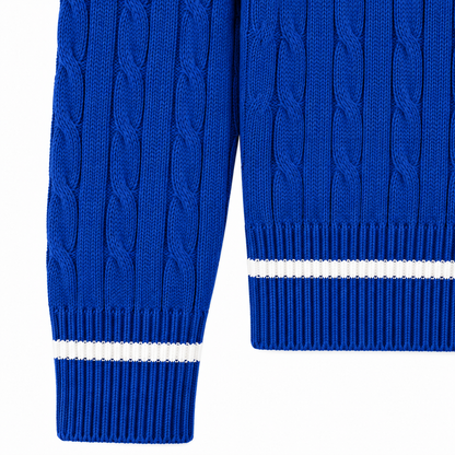 Royal blue cardigan cuff and hem detail with clean white ribbed stripes and cable-knit texture