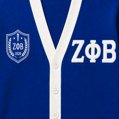 Close-up of original Zeta Phi Beta cardigan embroidery with white ZΦB letters and blue shield badge