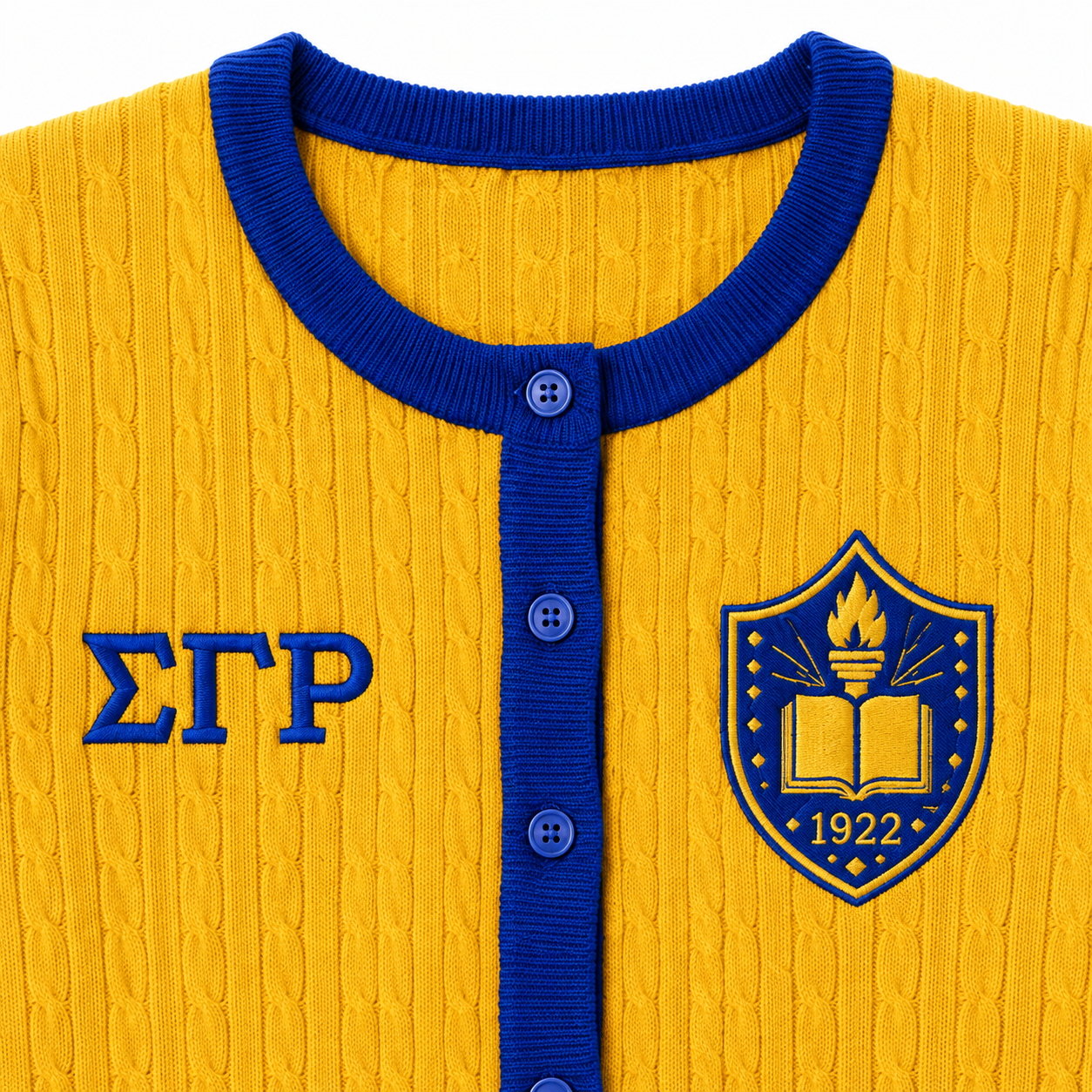 Close-up of yellow cable knit cardigan with royal blue ribbed collar, button placket and embroidered Greek letters