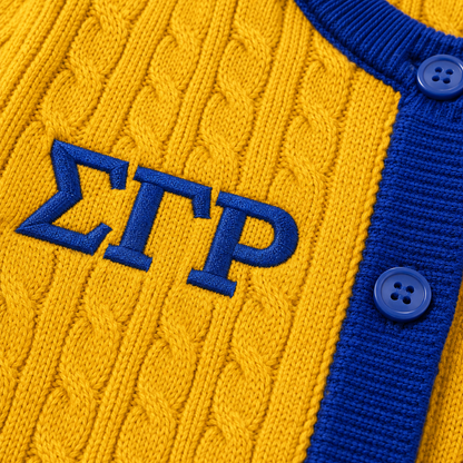 Close-up of cable knit texture with raised embroidery and premium craftsmanship on collegiate cardigan design