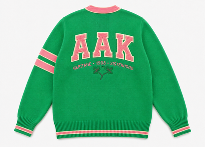 Green crew neck sweater, "AAK" print, pink rib cuffs & sleeve stripes