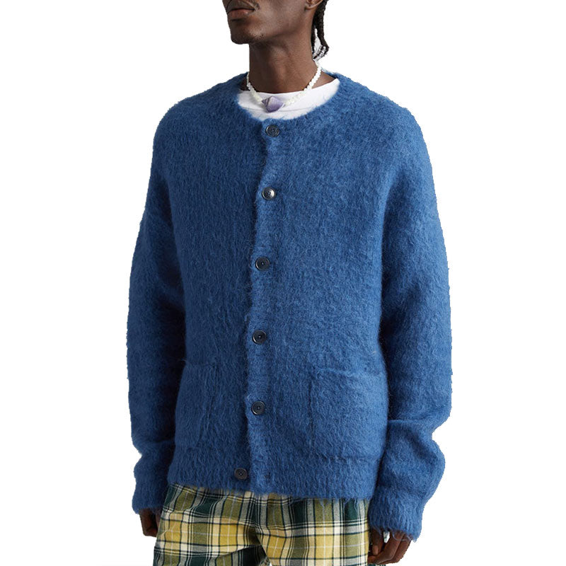 Side view of a man wearing a blue custom wholesale wool blend solid crew neck cardigan sweater over a white T-shirt