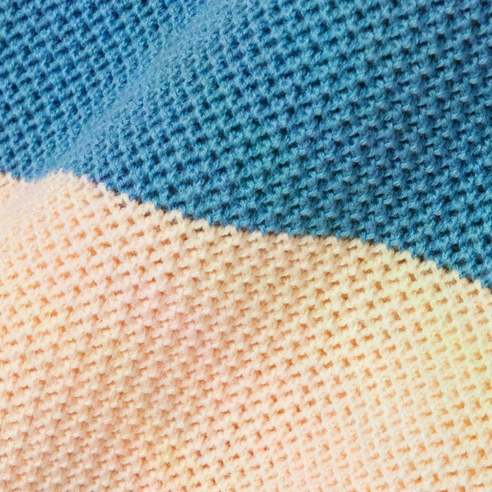 Close-up texture of blue and beige striped knitted fabric showing the fine knit pattern and color contrast.