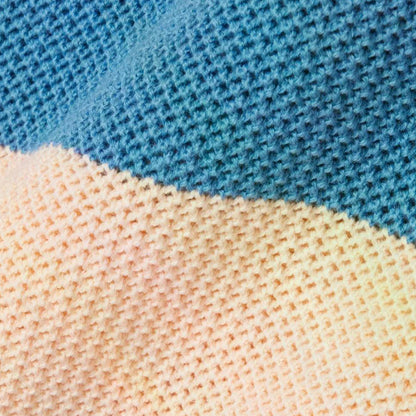 Close-up texture of blue and beige striped knitted fabric showing the fine knit pattern and color contrast.