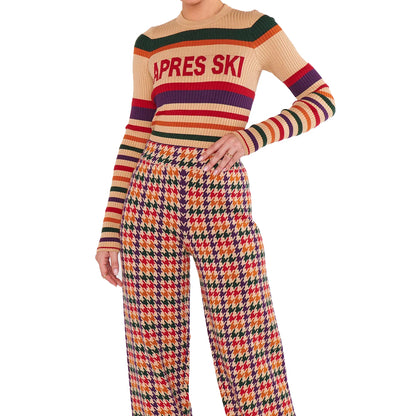 Full view of a beige striped knit sweater and matching pants set with geometric patterns.
