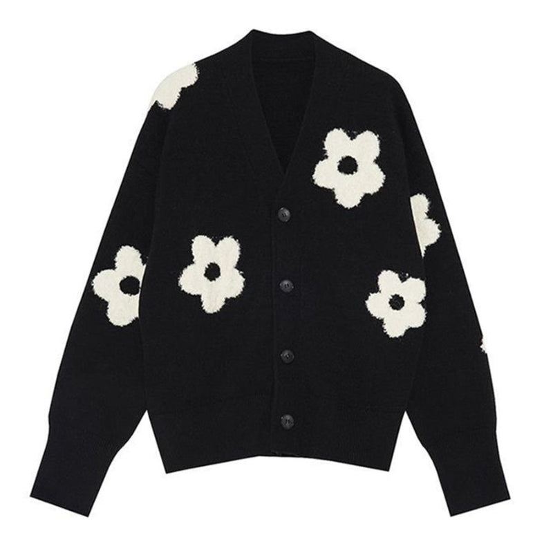 A black cardigan sweater with large white floral patterns and a button-down front, displayed on a plain white background.