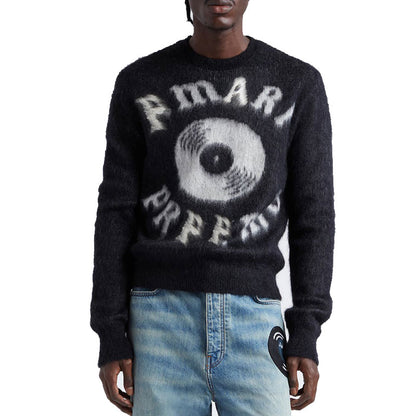 Front view of a custom mohair sweater with a bold letter design, worn by a model pairing it with light blue jeans.