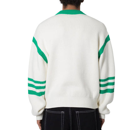 Back view of a man wearing a white 100% cotton pullover knit sweater with green color block design and polo collar, highlighting the green stripes on the sleeves and the fit of the garment.