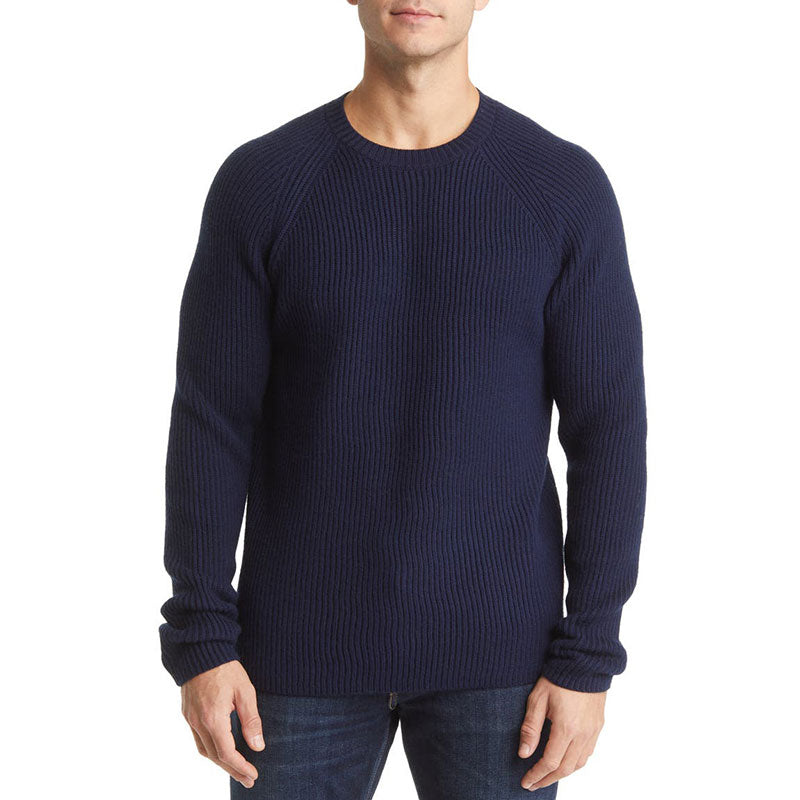 Front view of a man wearing a navy blue wool blend men's knit pullover sweater with raglan sleeves and rib design.