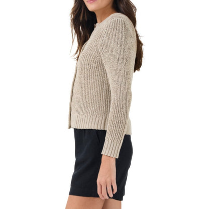 The side profile highlights the ribbed texture and the fitted silhouette of the sweater. The model is wearing the sweater with black high-waisted shorts, showing the sweater's length, which falls just at the hip. 