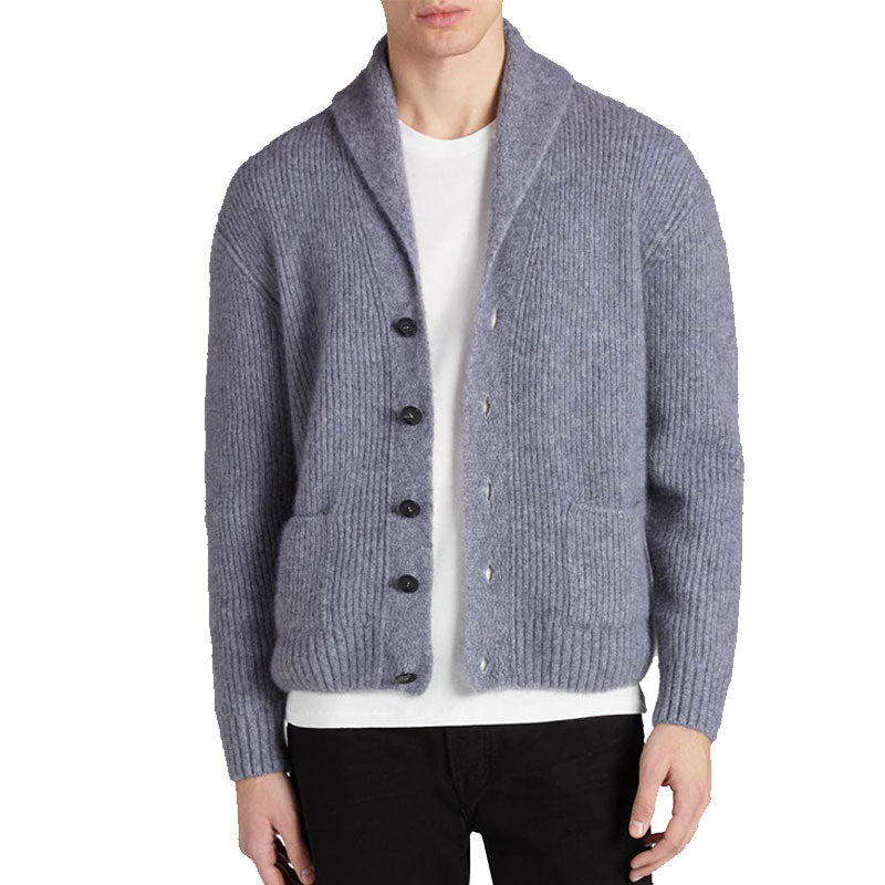 Front view of a model wearing a light grey custom shawl collar cashmere cardigan with button design and pockets.