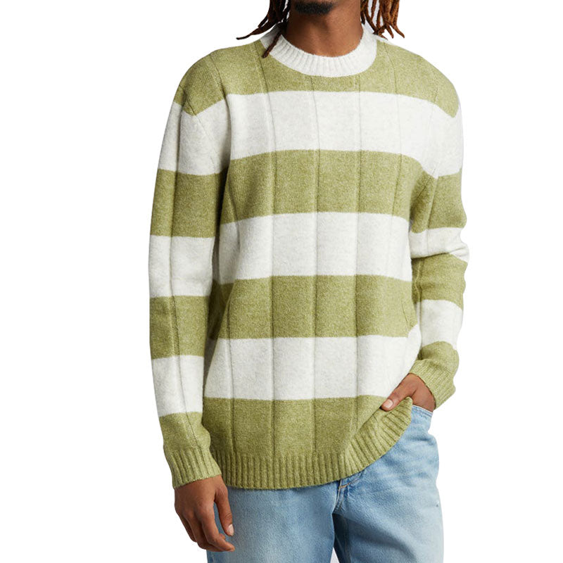 Front view of a man wearing a green and white striped cotton blend knit pullover sweater with a crew neck, ribbed cuffs, and hem.