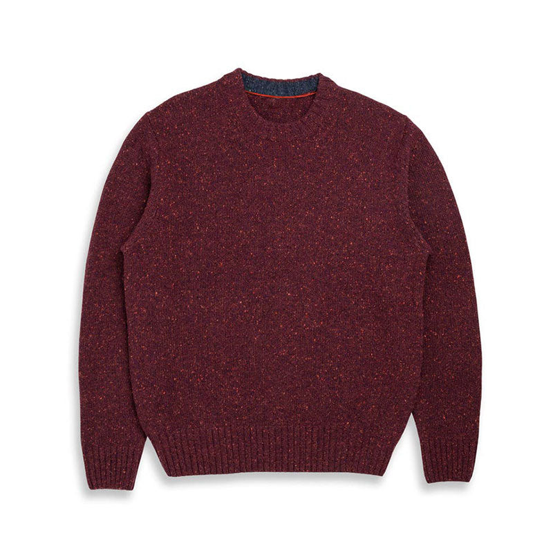 Flat lay of a maroon wool blend knit sweater with ribbed cuffs and hem, showcasing the front view of the garment.