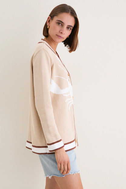 Side view of women's beige cardigan with contrast brown edges and long sleeves.