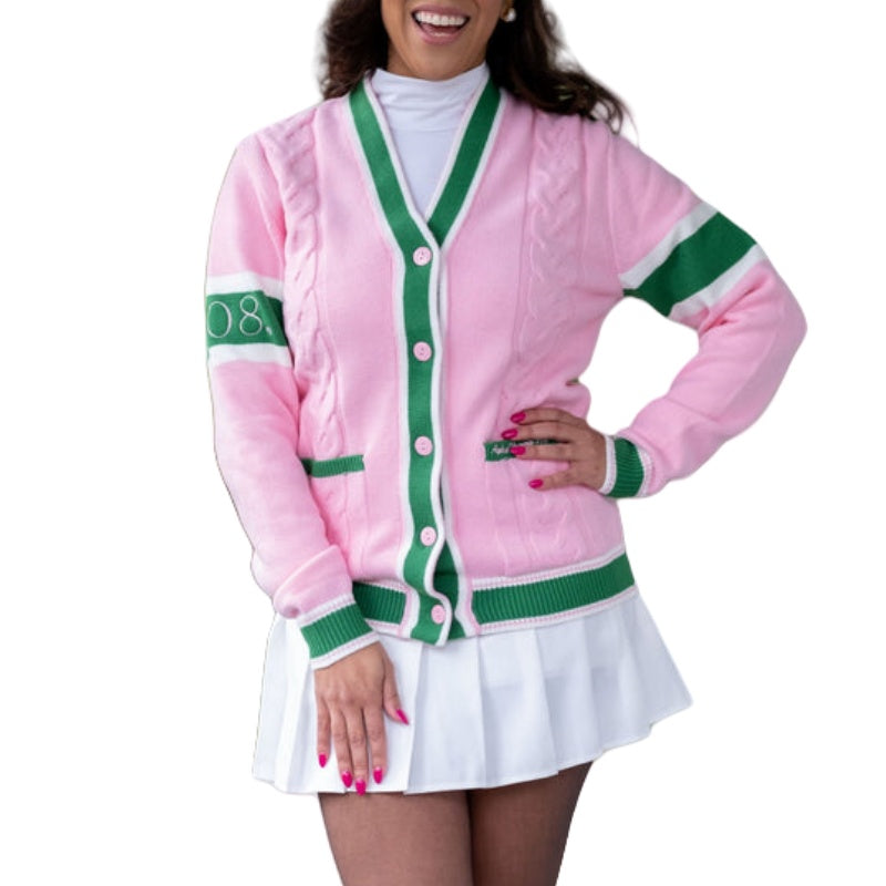 Happy woman in a custom 100% cotton pink cardigan with green and white stripes, featuring the number '08' on the sleeve. She is paired with a white pleated skirt, smiling and posing in a relaxed manner, exemplifying casual, trendy outerwear.