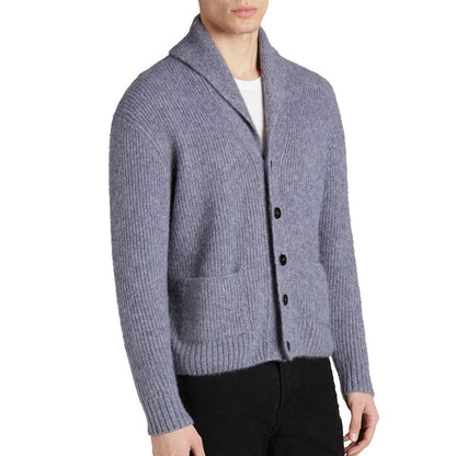 Side view of a model wearing a light grey custom shawl collar cashmere cardigan, showing the button design and pockets.