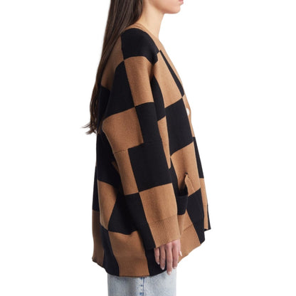 Side view of a custom 100% cotton women knit sweater with a black and brown checkerboard pattern, showcasing the oversized fit and long sleeves.