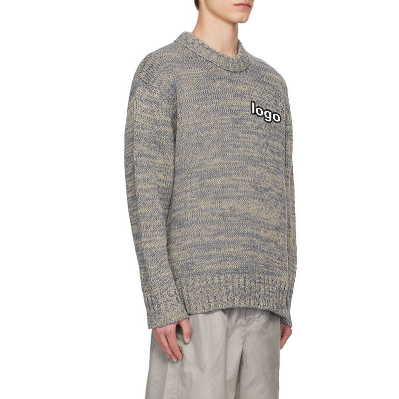 Side view of a custom blue and beige marled knit sweater with ribbed detailing and logo placement on the chest, showcasing the relaxed fit and textured design.