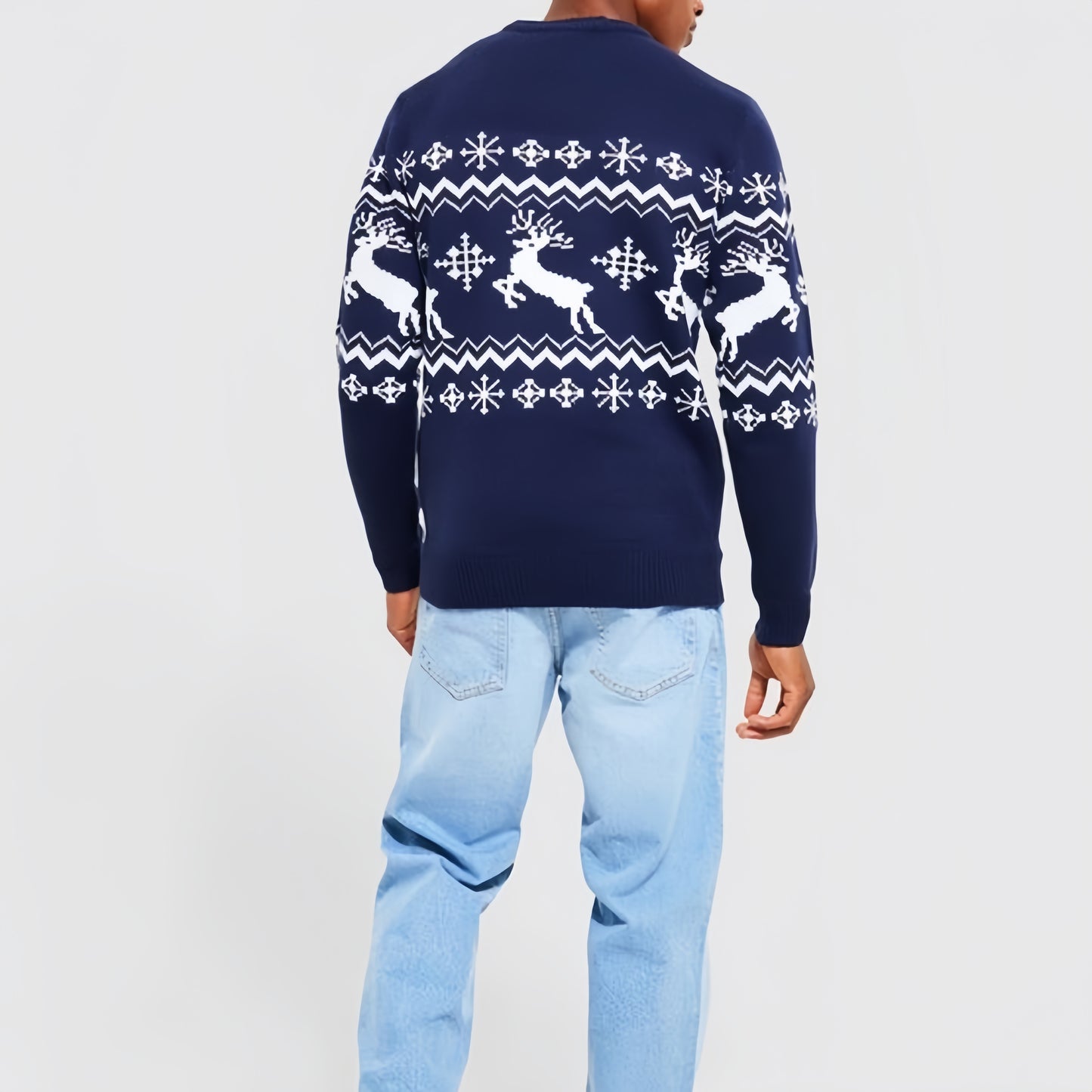 "Back view of a custom cashmere Christmas sweater featuring a navy reindeer Fair Isle pattern. The model is wearing light blue jeans, highlighting the sweater's design and fit, perfect for festive and winter occasions."