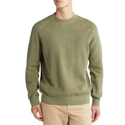 Front view of a man wearing a custom 100% cotton knit sweater in olive green, featuring a solid crew neck design and long sleeves.