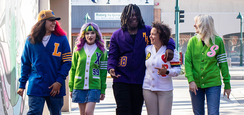 Custom letter sweater cardigans for sororities, fraternities, and HBCUs - diverse group wearing colorful custom designs.