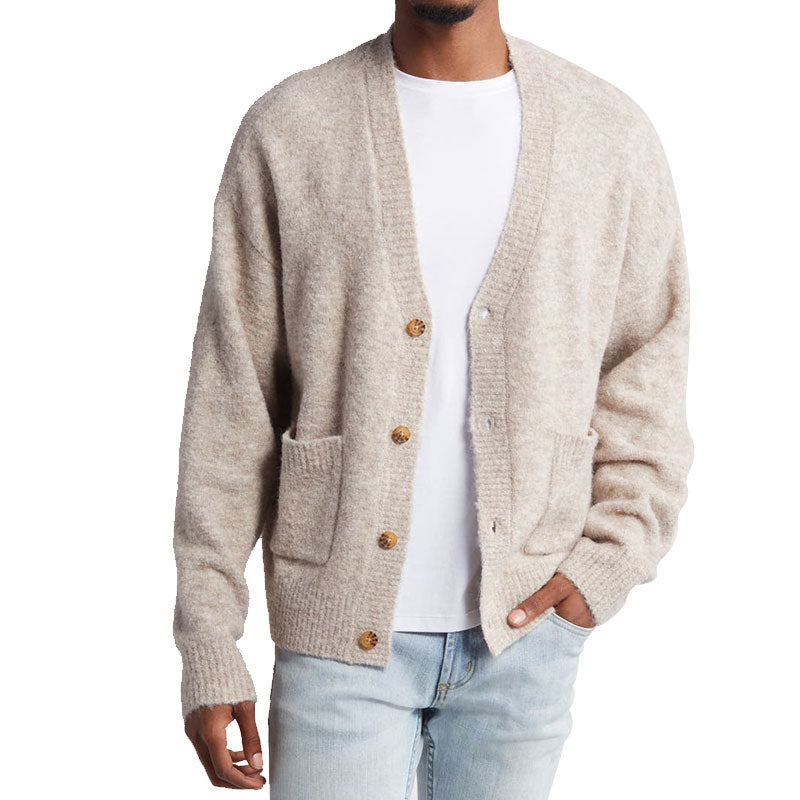 Front view of a model wearing a custom wool blend knit cardigan with front pockets, paired with a white t-shirt and jeans.