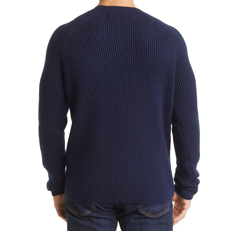 Back view of a man wearing a navy blue wool blend men's knit pullover sweater with raglan sleeves and rib design.